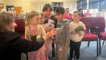 Children Valentina, Aurora, Leonardo and Atlas take part in the Anzac Day Commemoration Service held at Uniting Springwood aged care home. Picture supplied