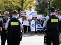A pro-Israel rally at the ANU. Police are between the two groups. Picture by Elesa Kurtz