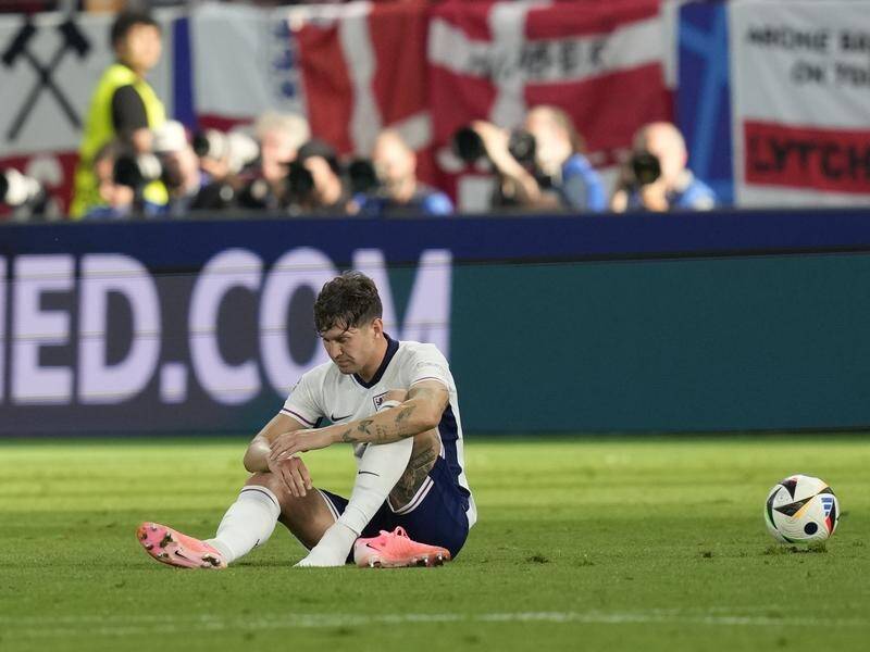 John Stones sits gloomily on the pitch after England's lacklustre 1-1 draw with Denmark at Euro 24. (AP PHOTO)